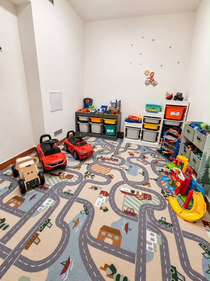 The corner with ride-on cars and a road playmat