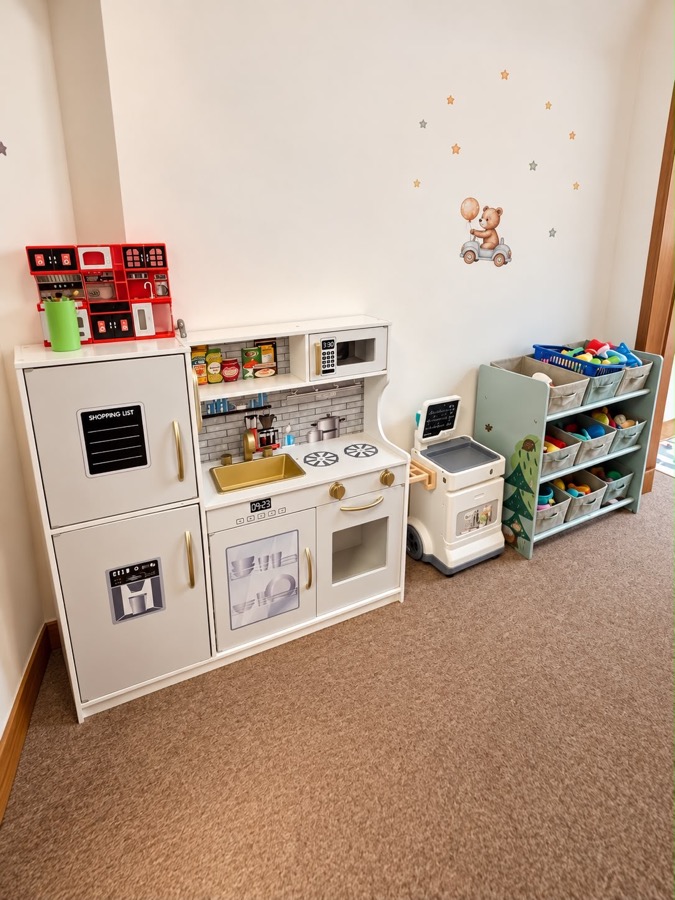A play kitchen and shelves of toys
